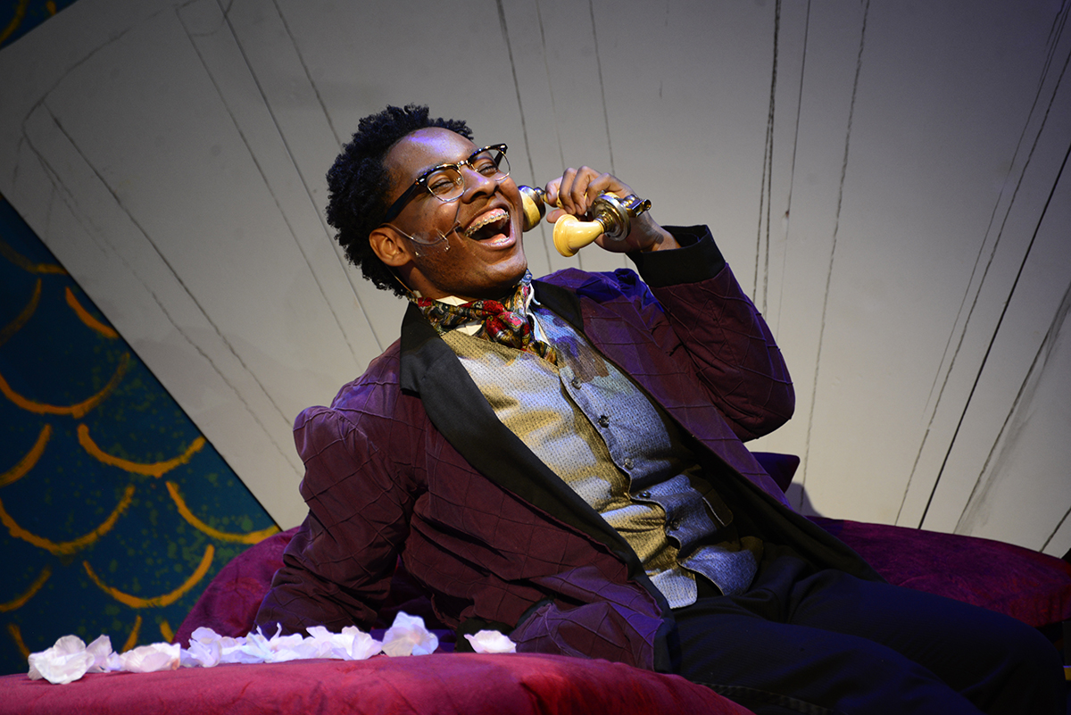 Anything Goes actor reclines and sings onstage.