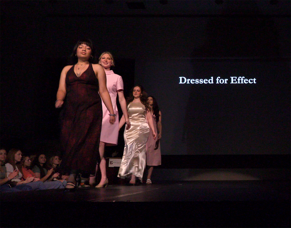 Models show designs on walk for display.