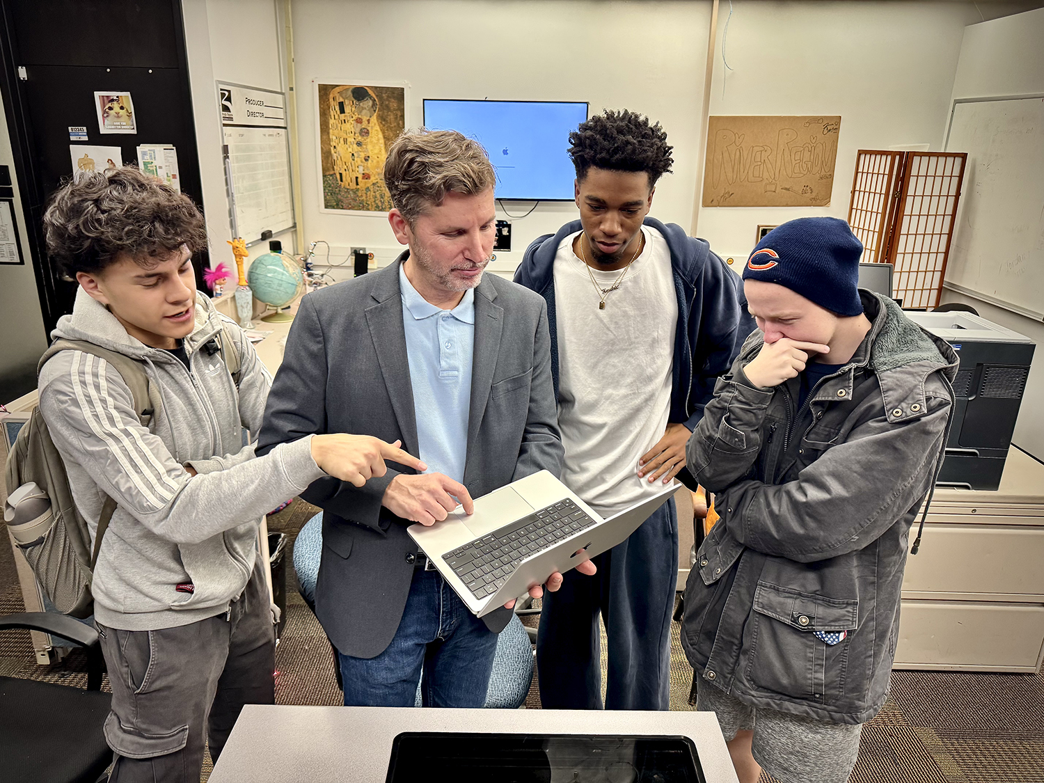 News team looking over stories, discussing ideas.