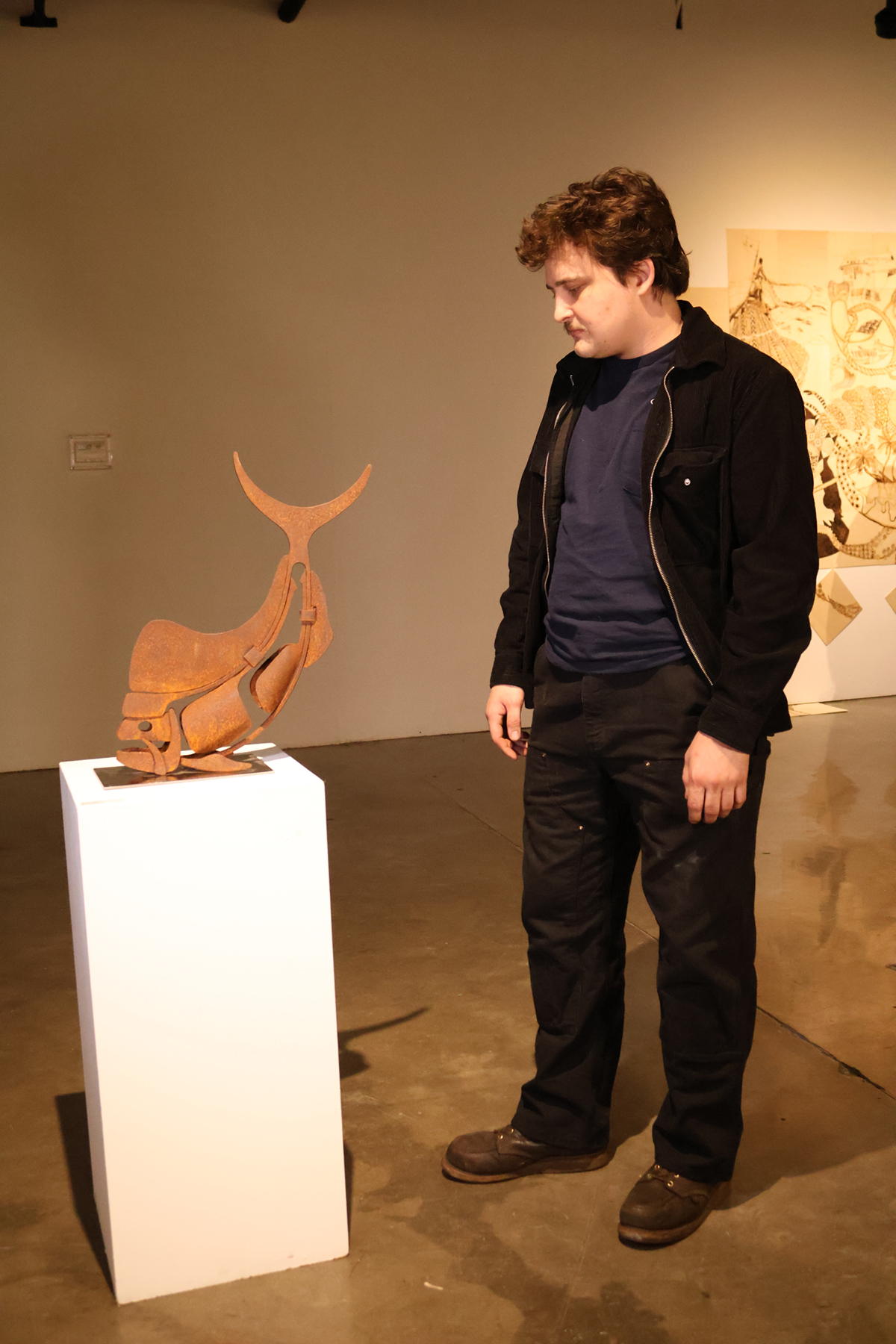 Beaty checking artwork.