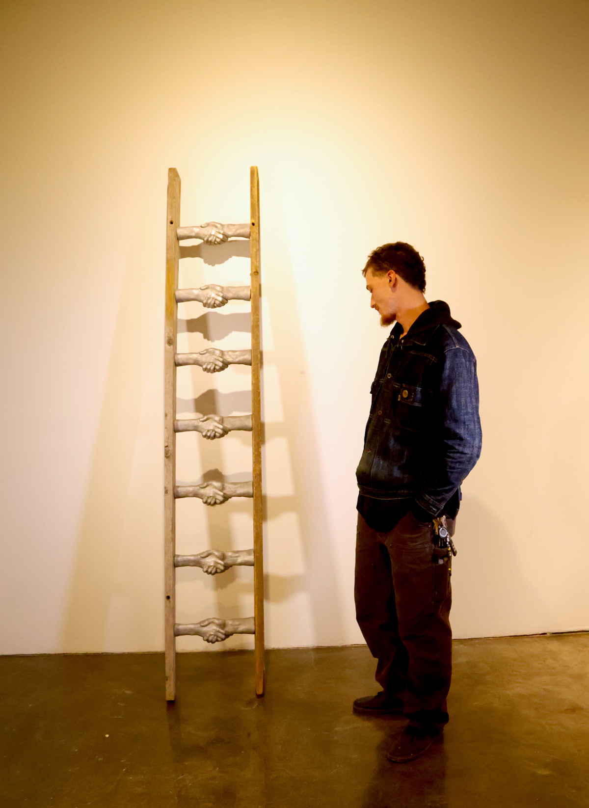 Image of Freund looking at art piece.