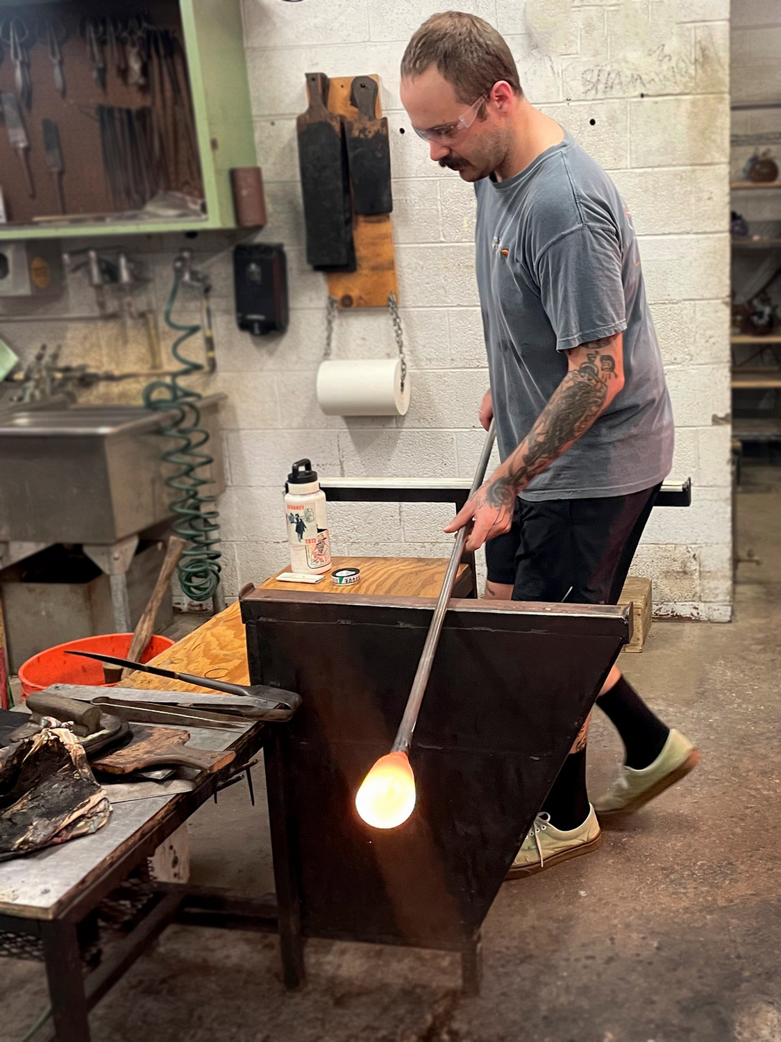 Glass artist with tools for work.