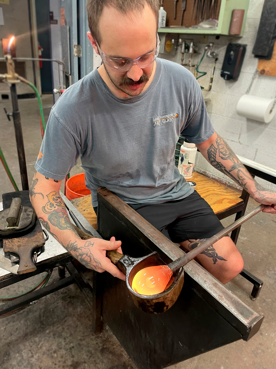 Glass blower working with hot material.